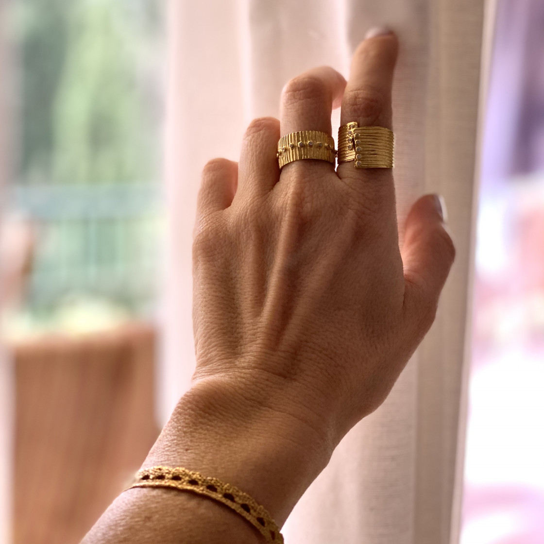 Gold broad cuff ring with ten zircon stones set along the edges, spiral hammered detail.