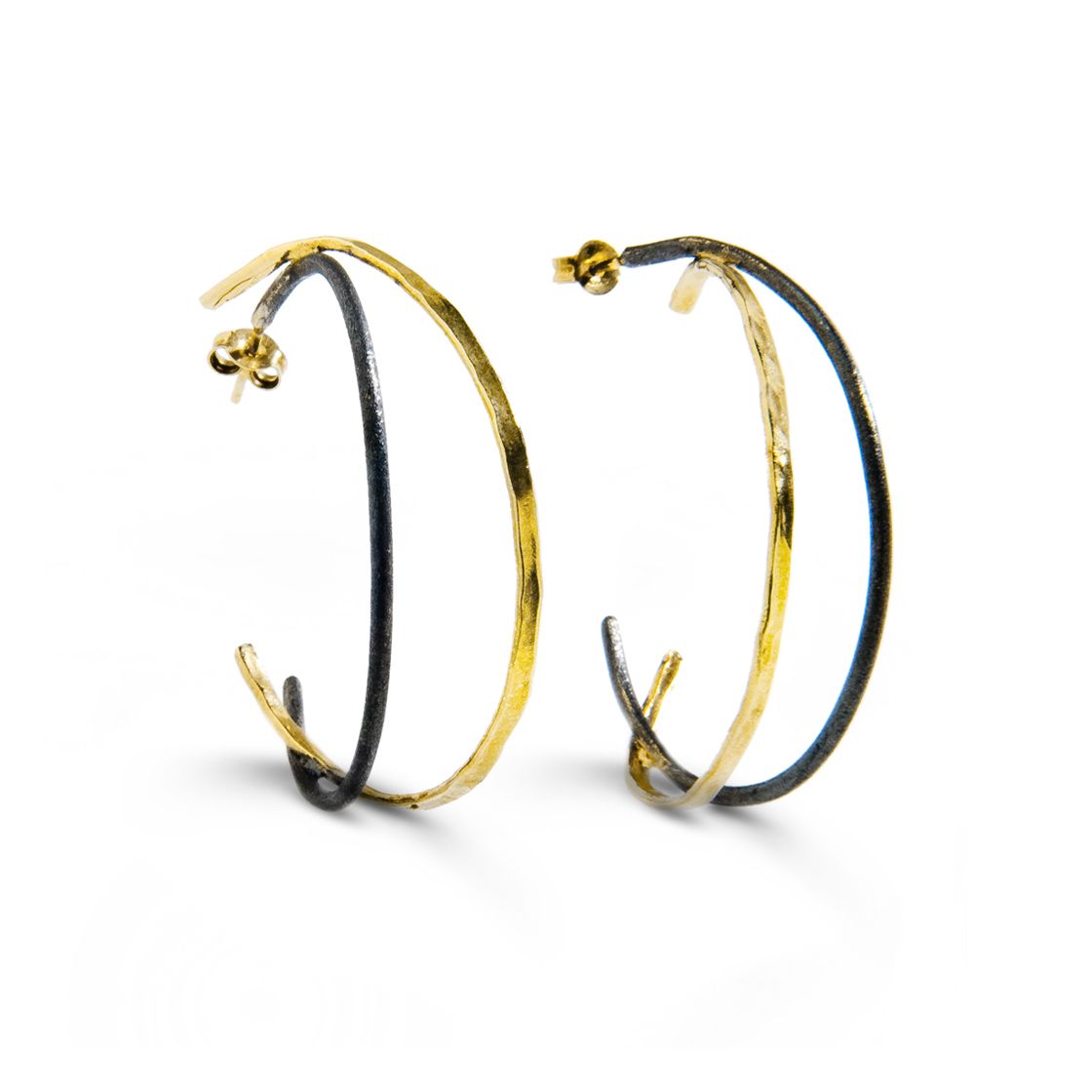 Hoop earrings that emphasize the subtle balance between black and gold.