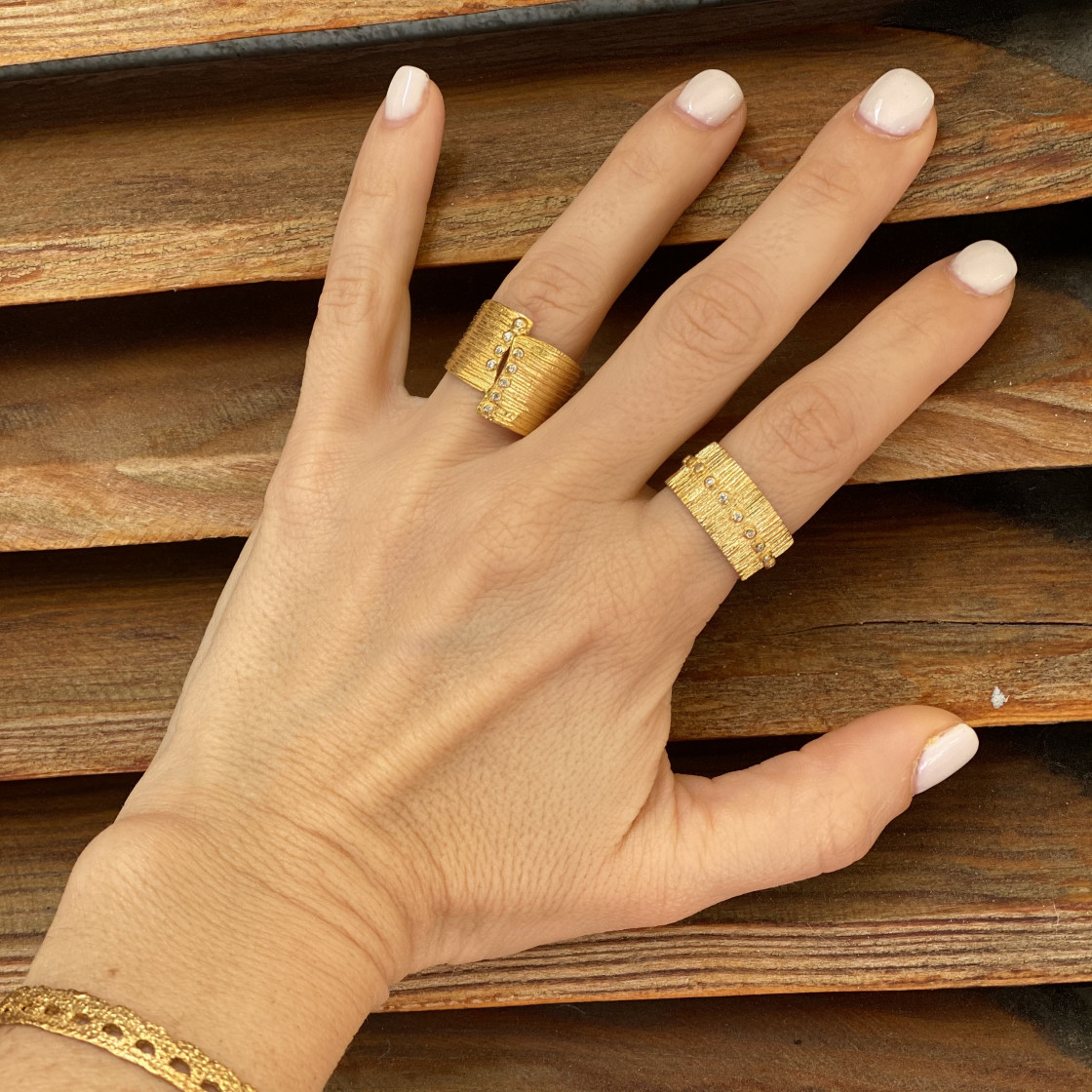 Gold broad cuff ring with ten zircon stones set along the edges, spiral hammered detail.