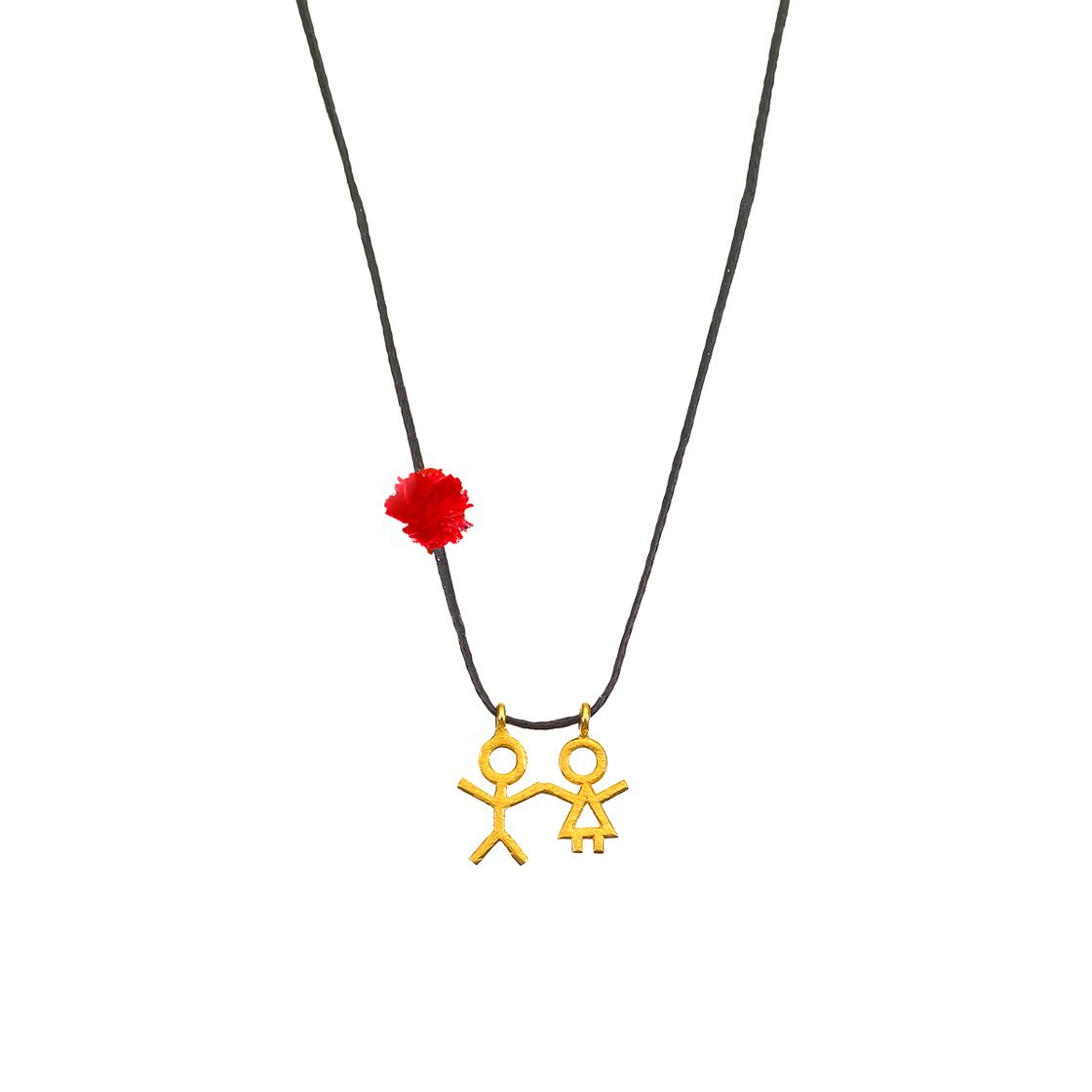 Gold boy holding a girl's hand charm with red tassle on black waxed cord.