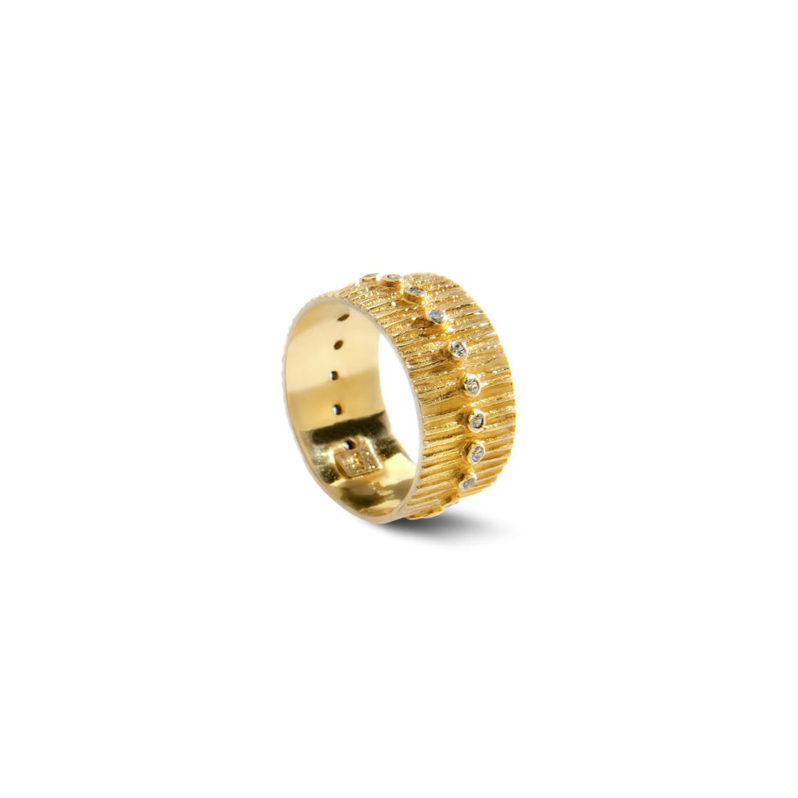 Bold golden line-hammered ring set with zircon stones.