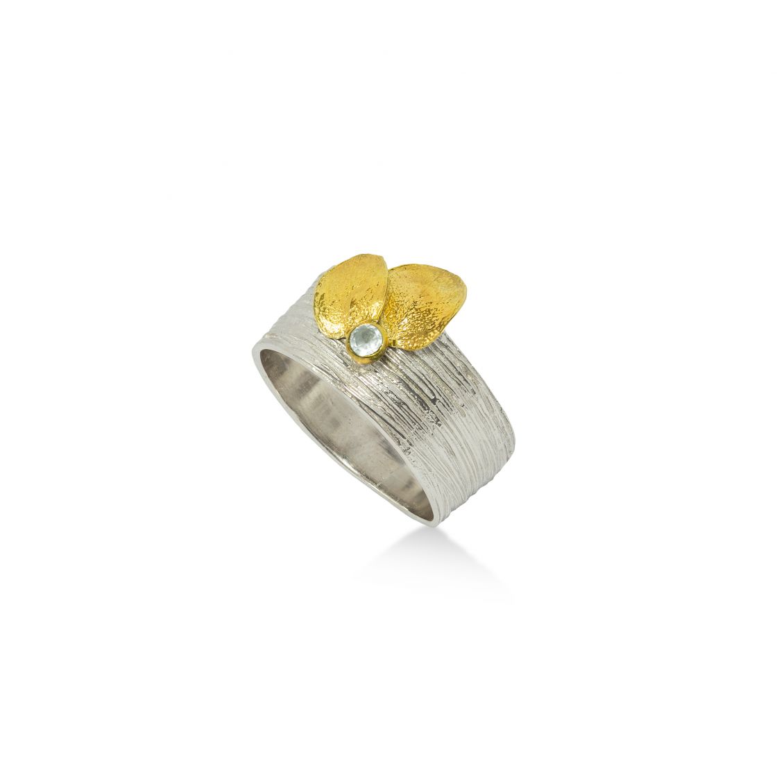 Wide silver ring with line-hammered finish, set with two gold leaves.