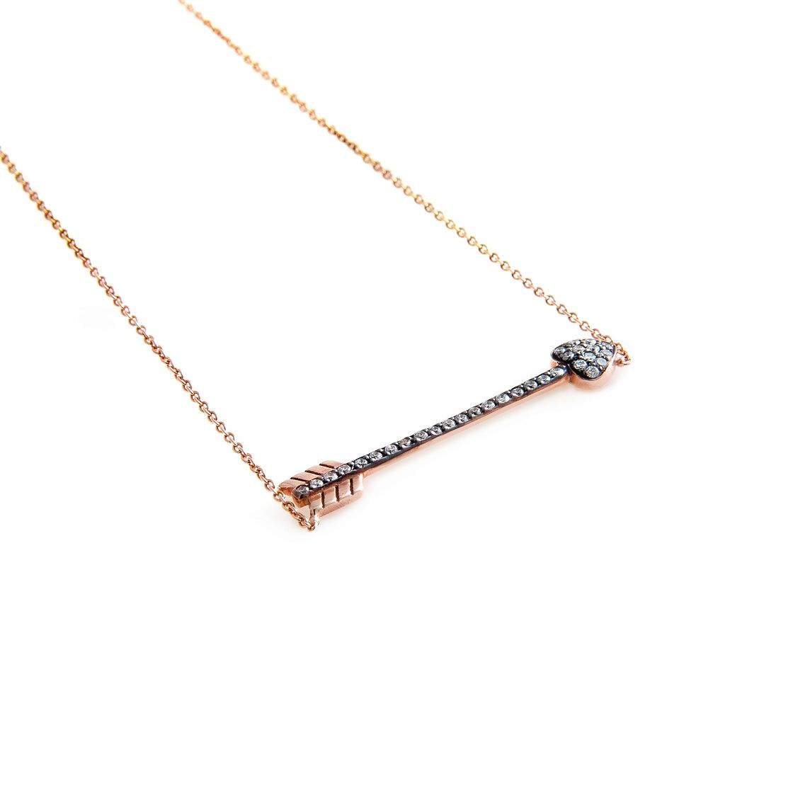 Rose gold arrow with black-gold detail and white brilliant cut diamonds, delicate rose gold chain.