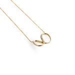 Small gold infinity charm inlaid with white brilliant cut diamonds, delicate gold chain.